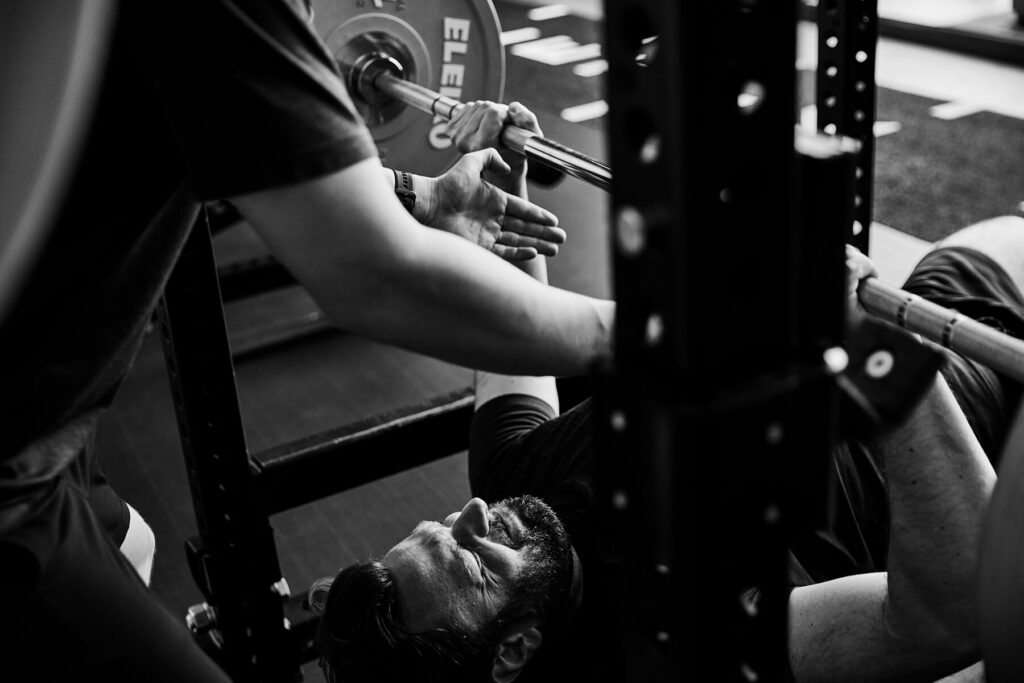 Trainer sichert aktiv beim Bankdrücken im Athletik Docks Studio St. Pauli Hamburg